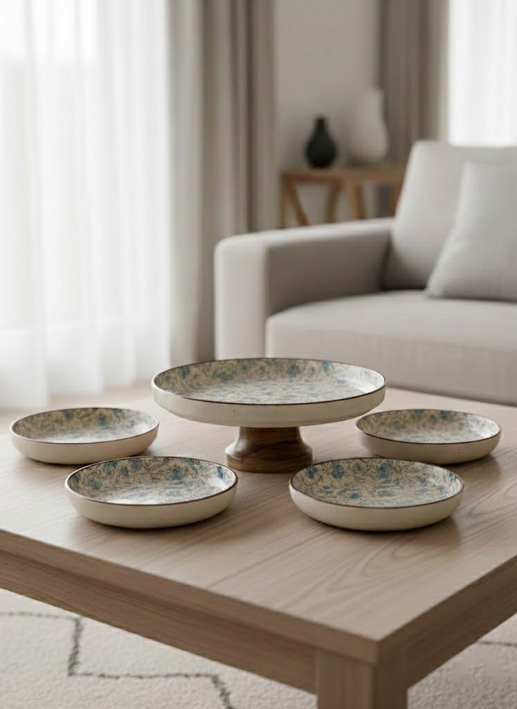 Set of ceramic plates on a wooden table in a living room setting