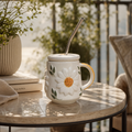 Decorative mug with sunflower design on a table outdoors