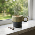 Steaming mug on a windowsill with coffee beans nearby