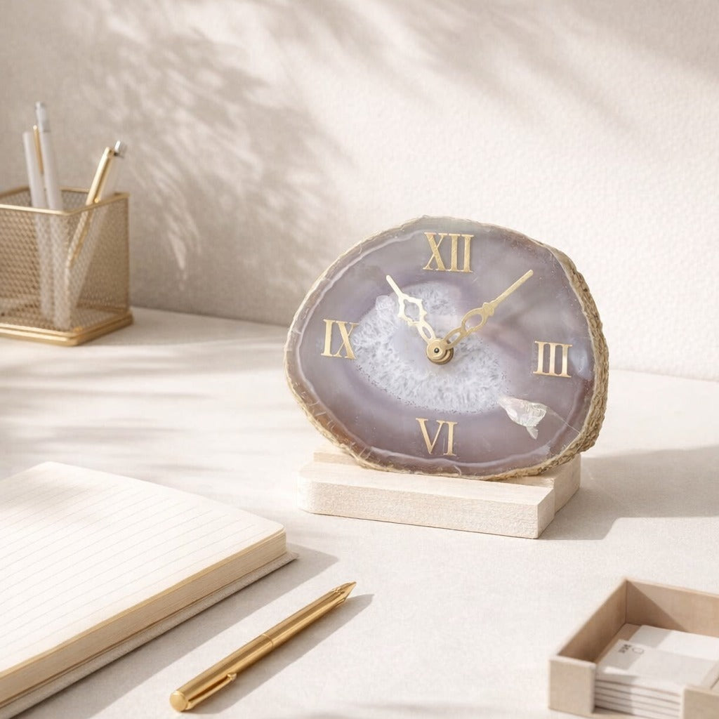 Decorative clock with Roman numerals on a desk with stationery items