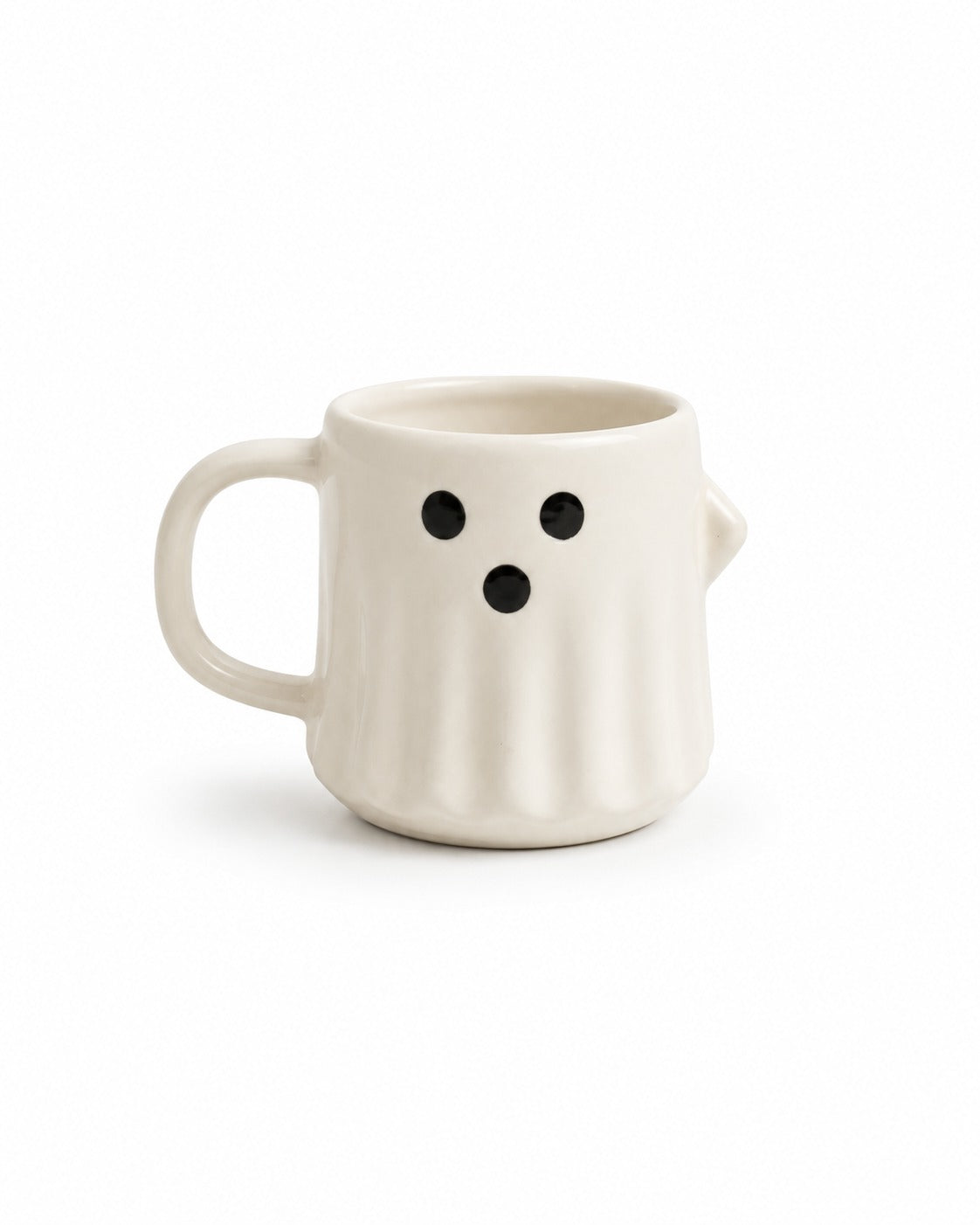 An off-white ceramic mug shaped like a ghost, featuring a simple black face with two eyes and a dot mouth, set against a plain white background.