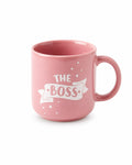 A pink ceramic mug with a white graphic banner that reads 'THE BOSS' and small white dots, shown on a clean white background.